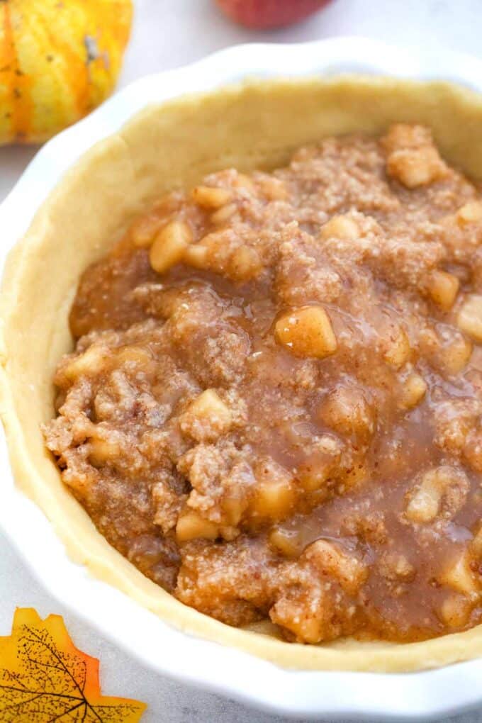 apple filling and pie crust in a pie dish