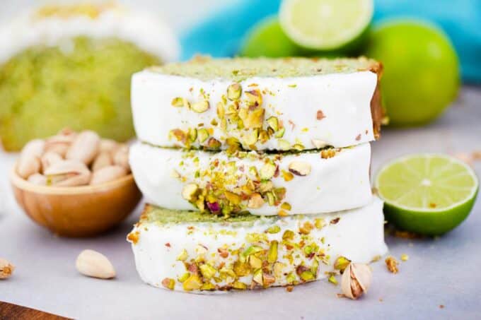 sliced of pistachio pound cake stacked on top of each other