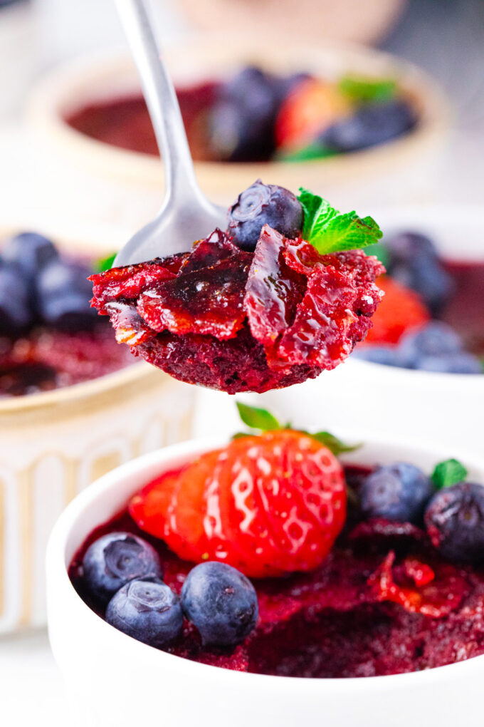 A spoonful of red velvet creme brulee with crispy top.
