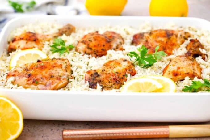 lemon chicken and rice casserole with lemons in the background