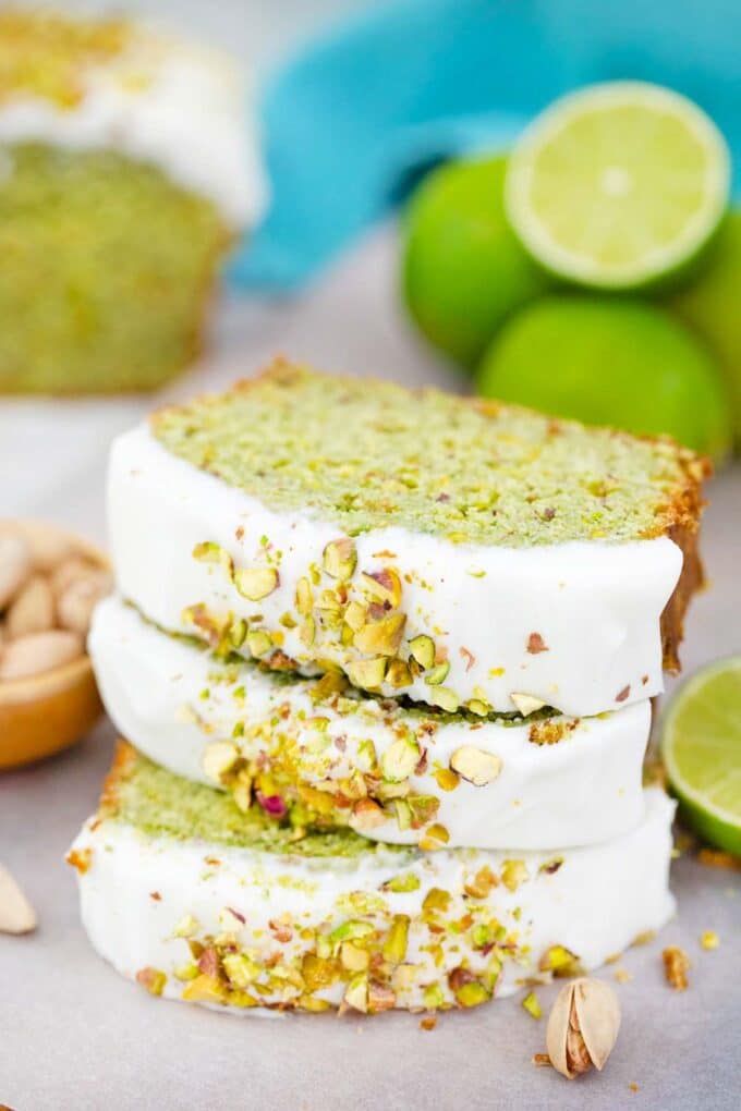 three pistachio pound cake slices stacked and lime in the background