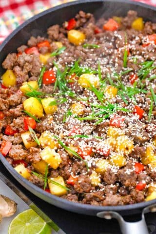 a skillet with cooked ground beef pineapple and bell pepper