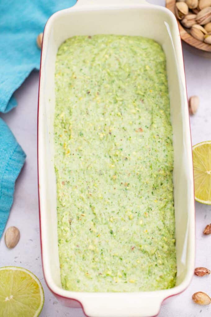 raw pistachio pound cake in a baking loaf pan
