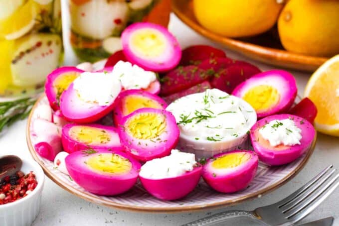 a plate with pickled eggs and dipping sauce