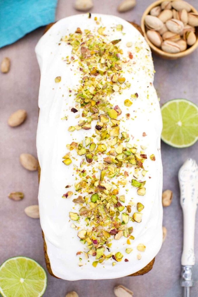 overhead shot of pistachio pound cake topped with white glaze and chopped pistachios