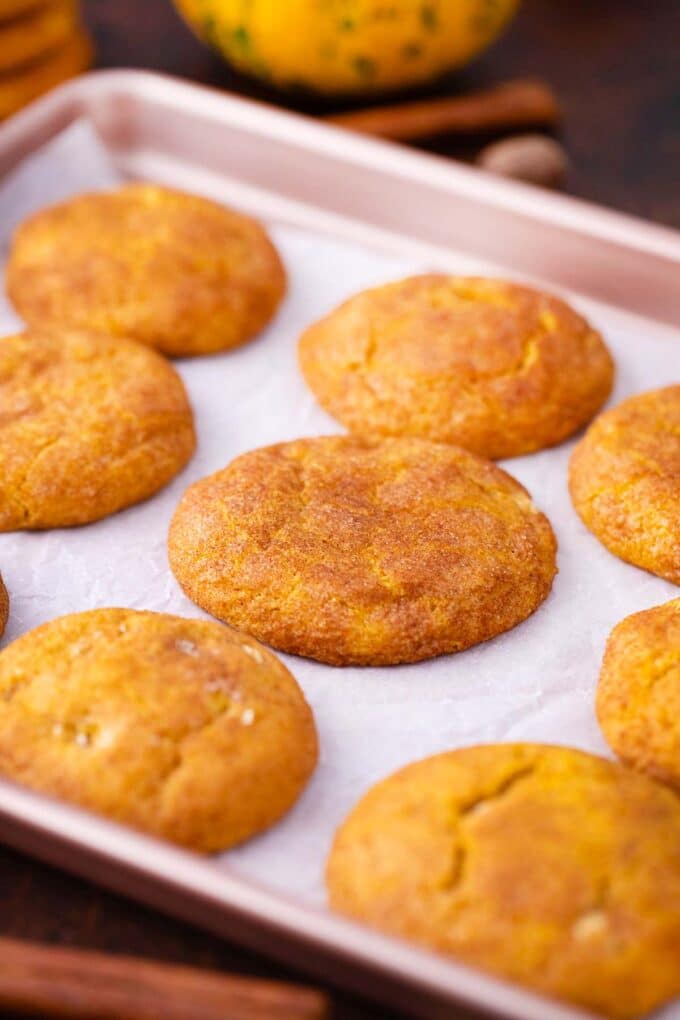 baked white chocolate chip pumpkin snickerdoodle cookies on a baking sheet