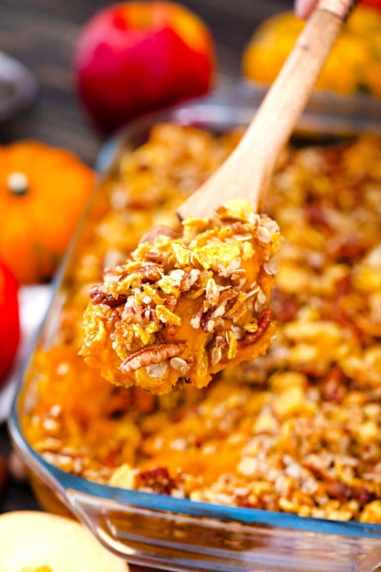 a spoonful of apple butternut squash casserole on top of the casserole dish