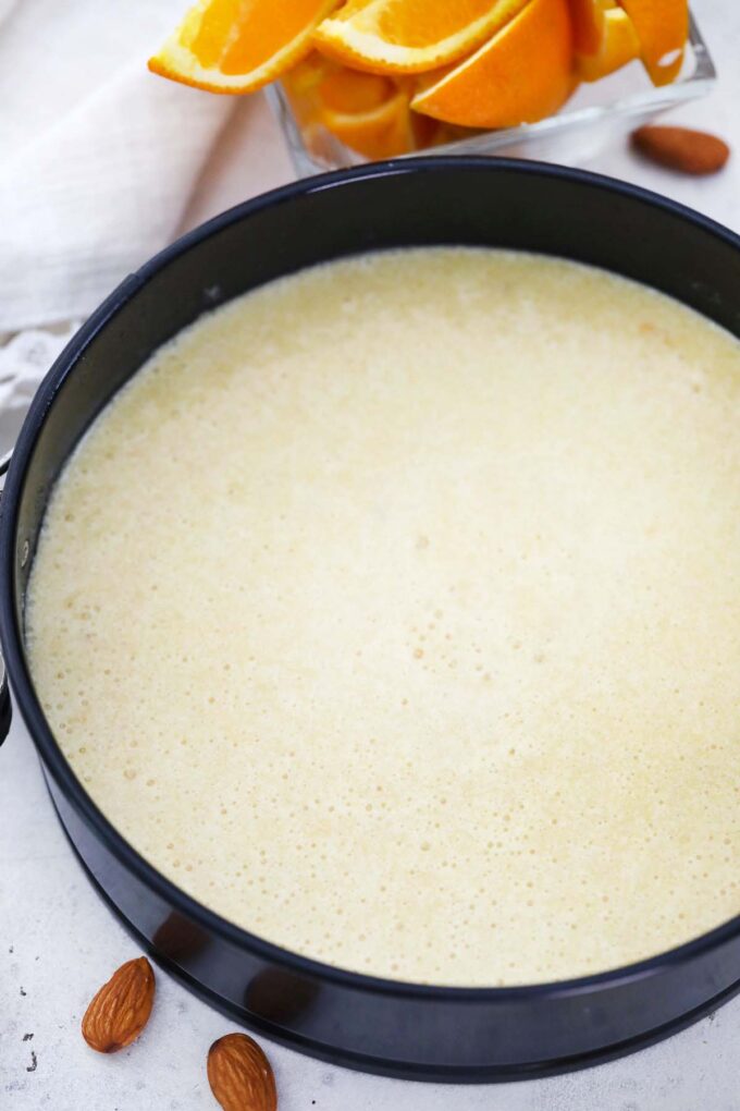 almond orange cake raw batter in a springform pan