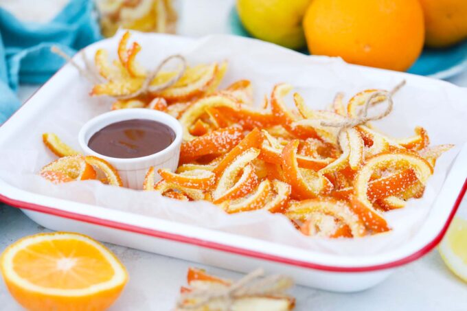 a tray with candied citrus peel and chocolate for dipping