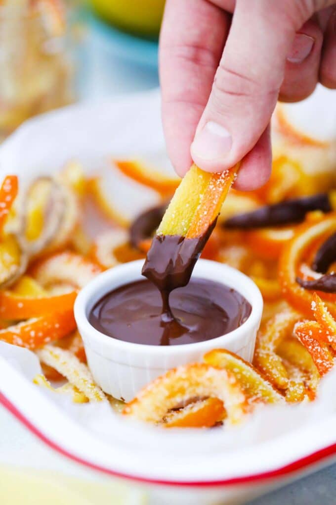 dipping candied citrus peel in melted dark chocolate