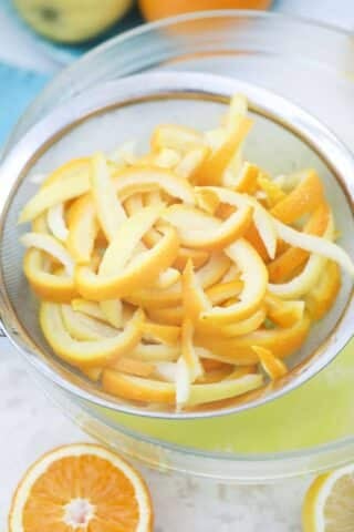 draining citrus peel in a colander