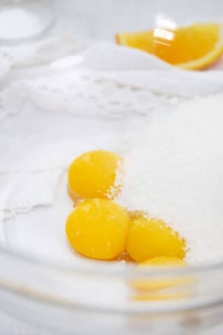egg yolks and white sugar in a bowl