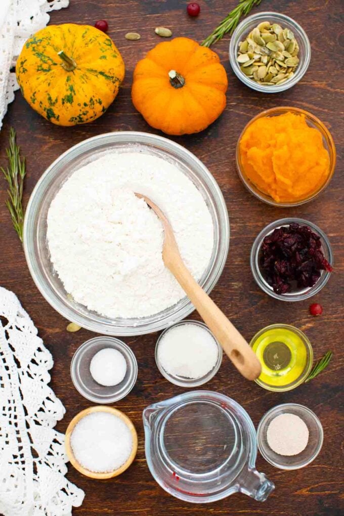 overhead shot of pumpkin focaccia ingredients in bowls on a wooden table