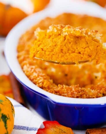 scooping a large spoonful go pumpkin gratin