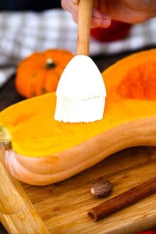 brushing a butternut squash with oil