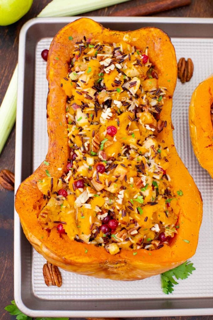 overhead shot of stuffed butternut squash on a baking sheet