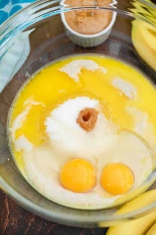 sugar eggs and melted butter in a mixing bowl