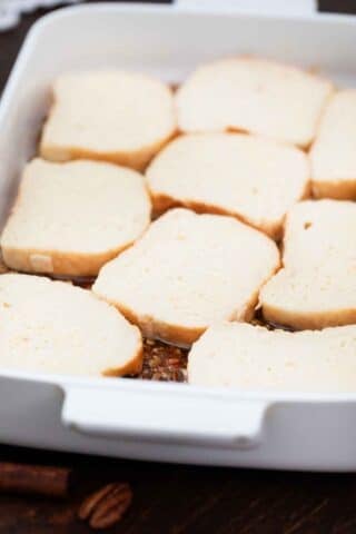 arrange bread slices on top of the pecan pie mixture in the baking dish