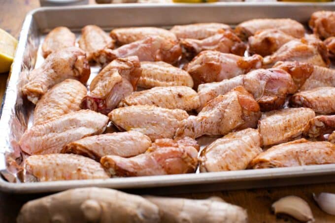 raw chicken wings on a baking sheet