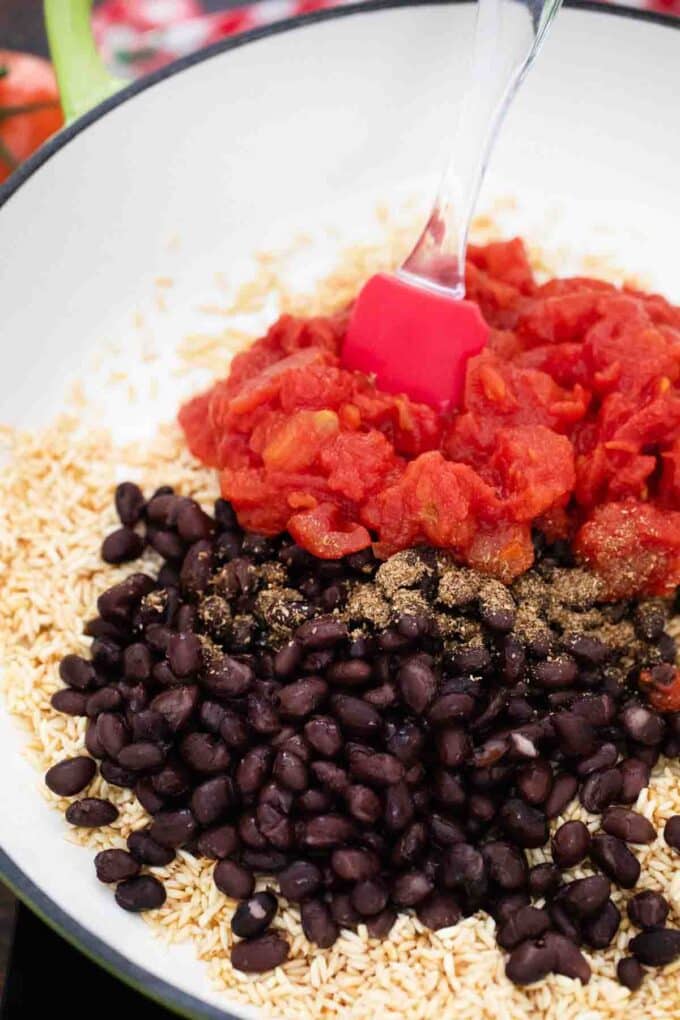 rice beans and diced tomatoes in a skillet