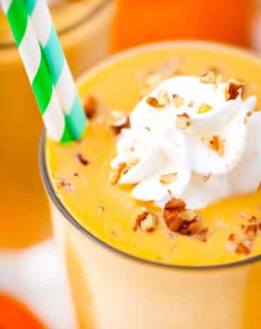 close shot of vegan pumpkin pie smoothie with whipped cream