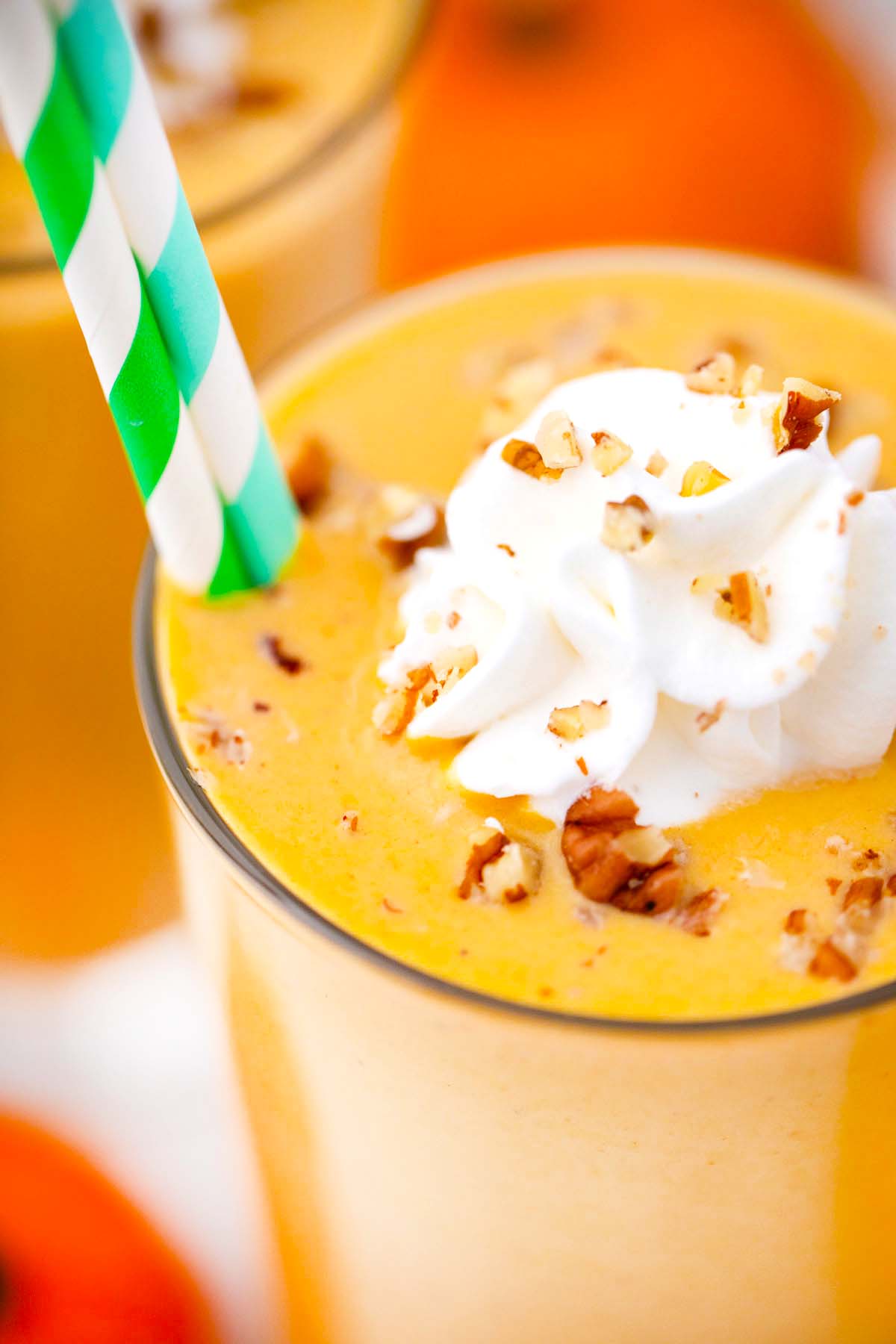 close shot of vegan pumpkin pie smoothie with whipped cream