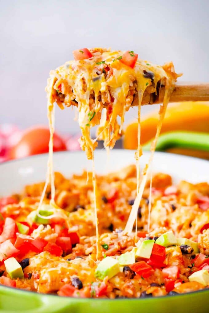 a cheesy spoonful of chicken burrito skillet pulling strings of cheese up