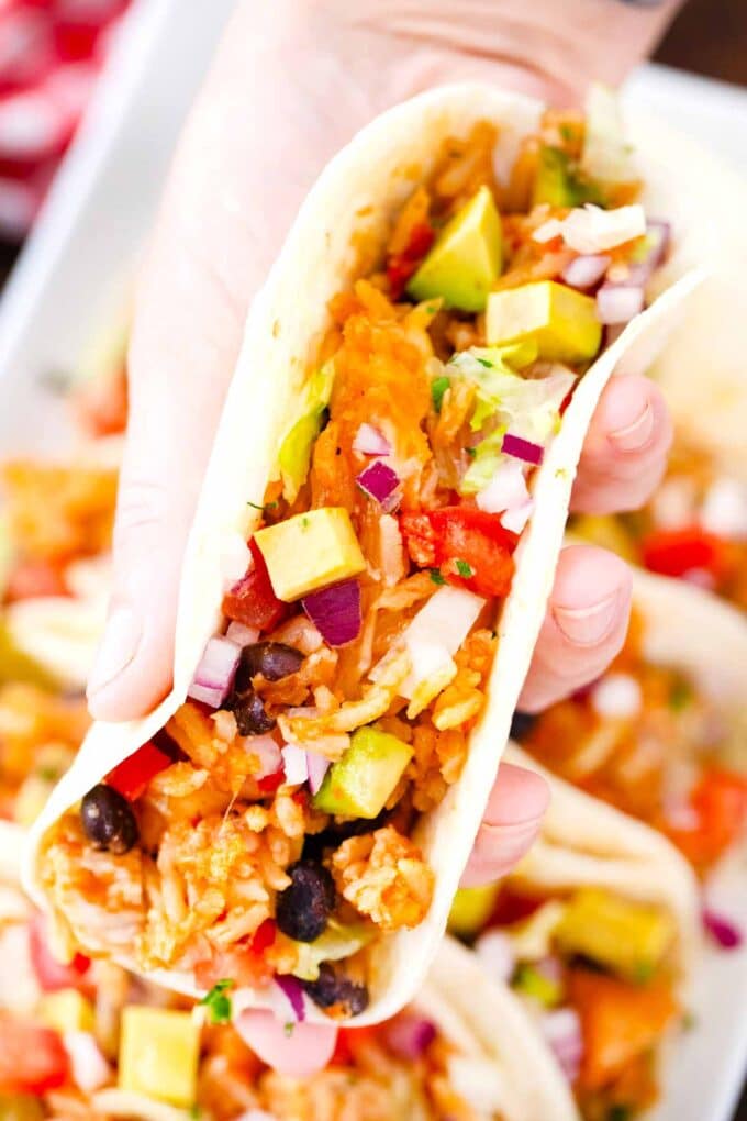 a hand holding chicken burrito skillet taco tortilla