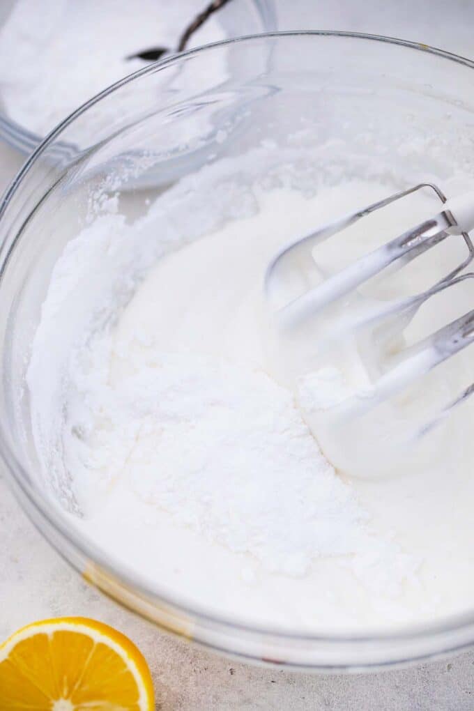 a bowl of fluffy egg white with a mixer in it