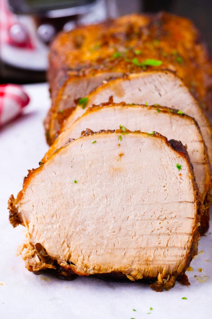 Sliced crockpot balsamic pork loin on a plate.