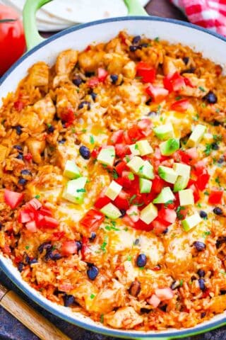 overhead shot of mexican chicken burrito skillet topped with salsa and avocado