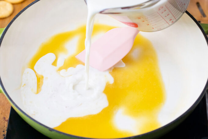 Stirring milk into a roux.