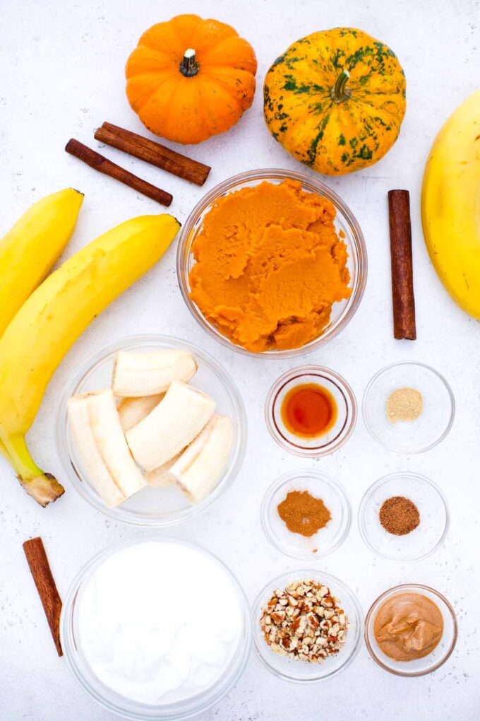 overhead shot of pumpkin pie smoothie ingredients in bowls on a table
