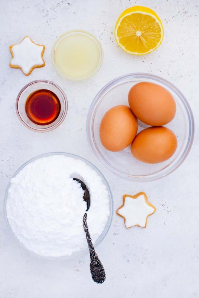 overhead shot of royal icing ingredients in bowls on a table