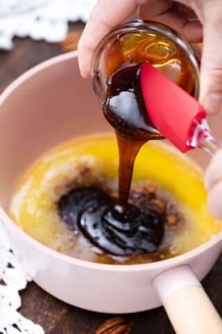 pouring maple syrup into a saucepan