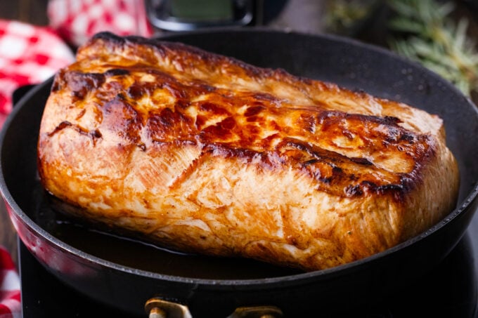 Searing a piece of pork loin.