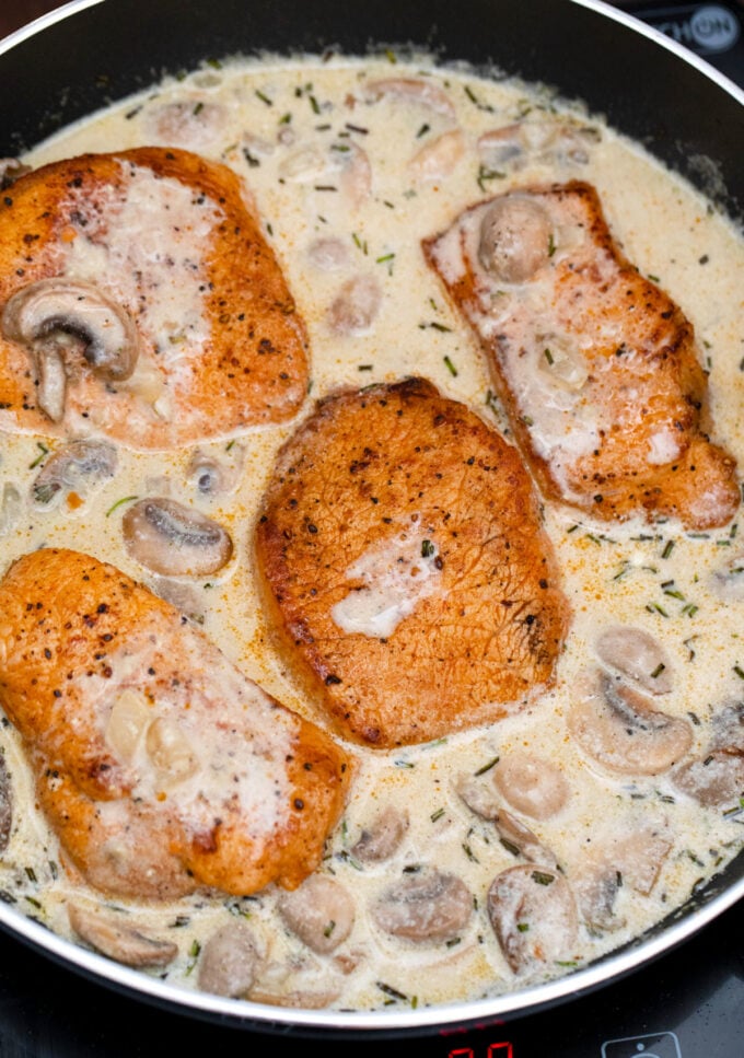 Browned pork chops in creamy mushroom sauce.