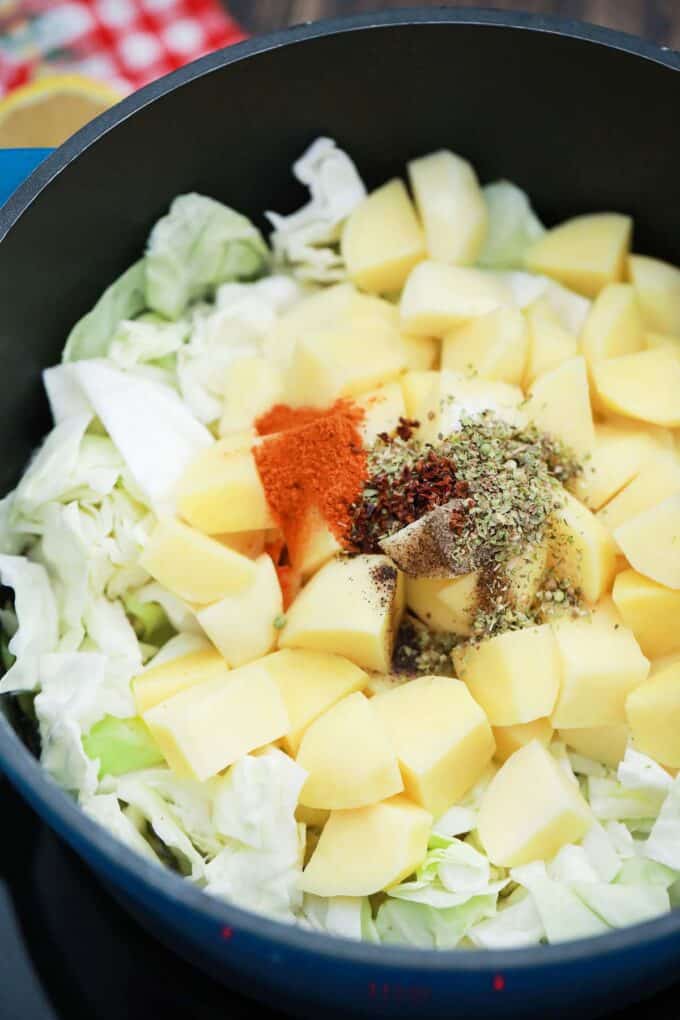 Cabbage and potatoes cooking in a pot.