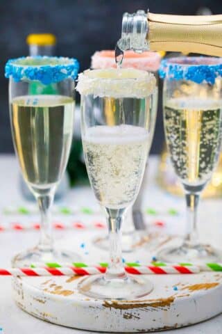 pouring champagne into a glass with a sprinkle rim