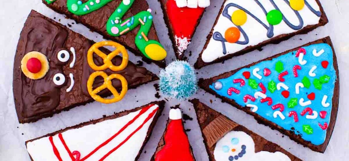 overhead shot of christmas brownie pops slices decorated as grinch Santa reindeer gift box christmas tree