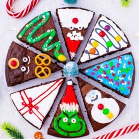 overhead shot of christmas brownie pops slices decorated as grinch Santa reindeer gift box christmas tree