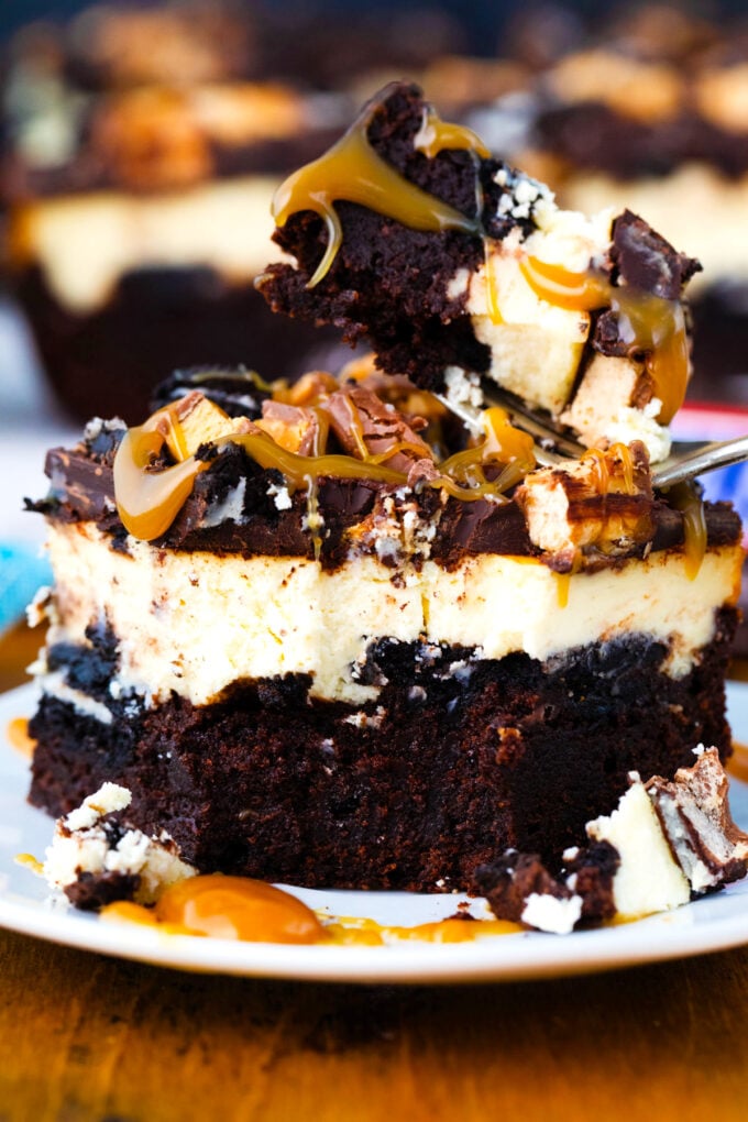 A bite of slutty cheesecake brownie bars.