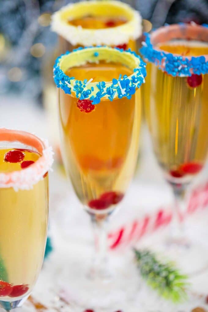 festive champage cocktail with blue sprinkle rim
