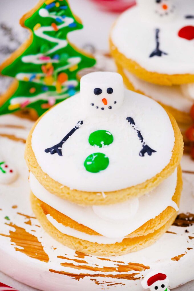 a stack of melted snowman cookies recipe with more cookies in the background
