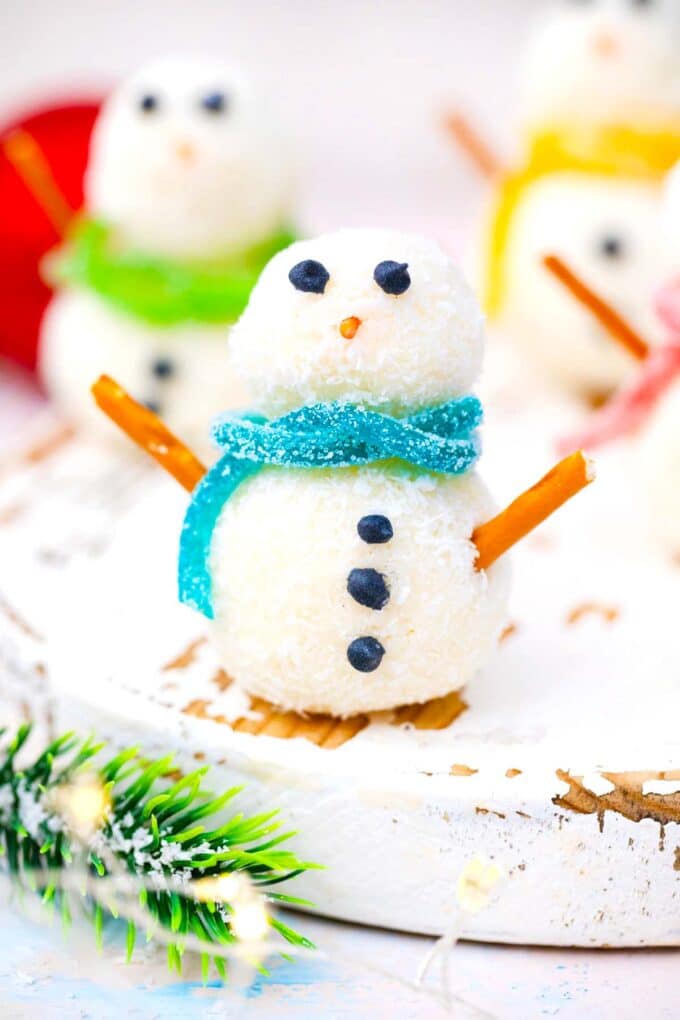 no bake snowman truffles with green blue and yellow candy scarfs