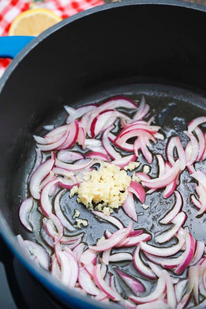Sautéing garlic and onion in a pot.