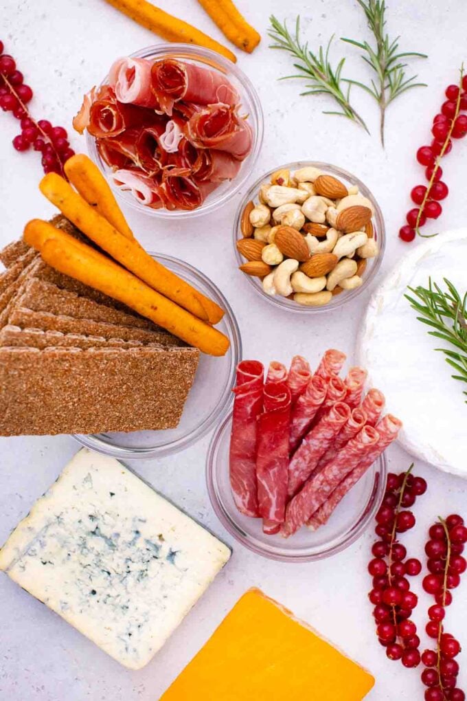 overhead shot of cheese meat and crackers to make a santa claus cheese board