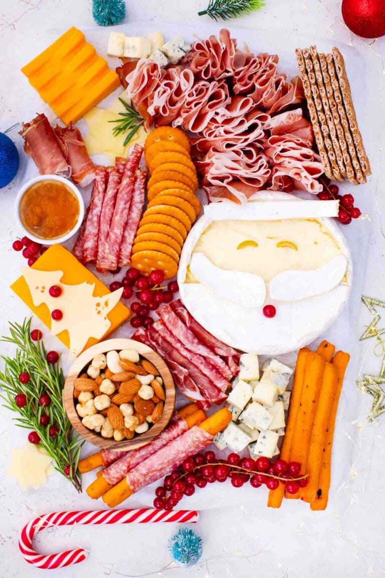 overhead shot of santa claus cheese board with christmas tree shaped cheese