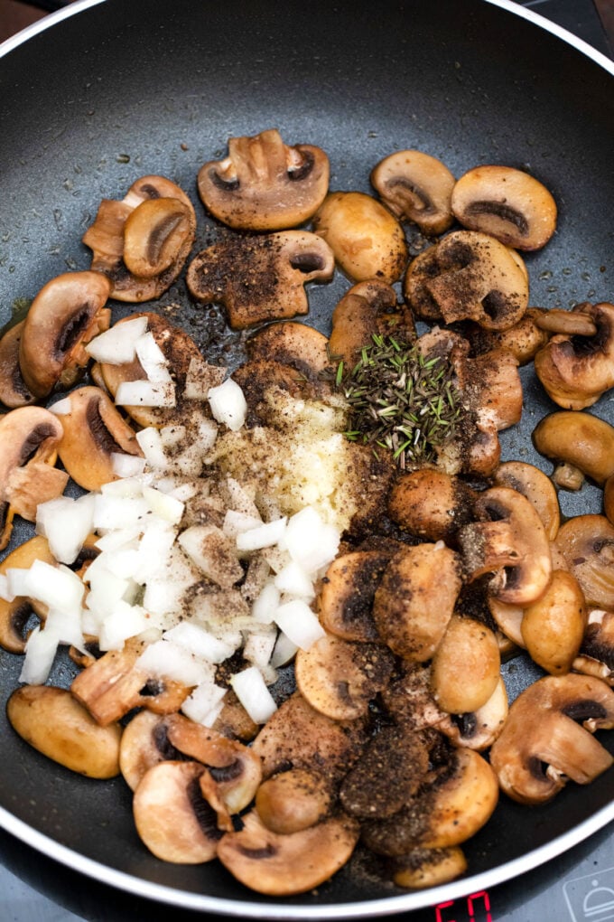 Sautéing onion, herbs, and mushrooms.