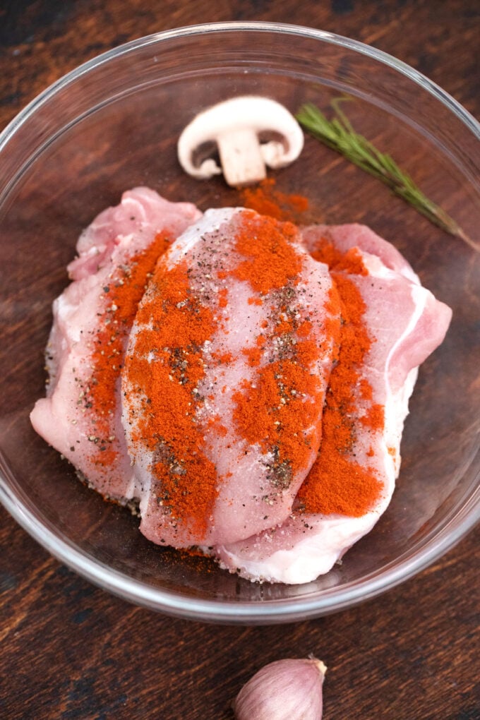 Seasoning pork chops.